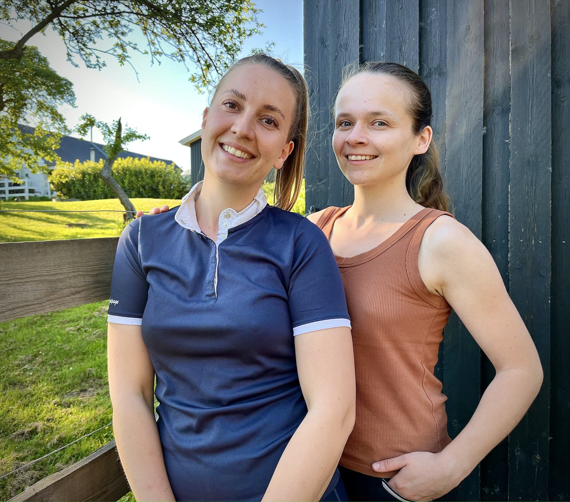 Cappall_Founder_Emmi_and_Anna standing by a fence smiling